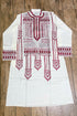 White embroidered kurta with red patterns on a wooden surface